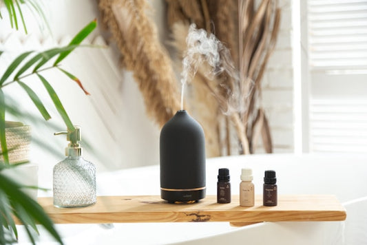 An elegantly designed room filled with diffuse, soft sunlight and an array of colorful aroma oil bottles on a vintage wooden table, with a serene person practicing meditation surrounded by gentle wisp
